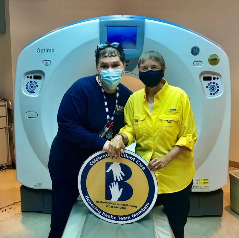 Mary Jo Cauley, left, is shown with grateful patient Kim King in front of the CT scan at Beebe. SUBMITTED PHOTO